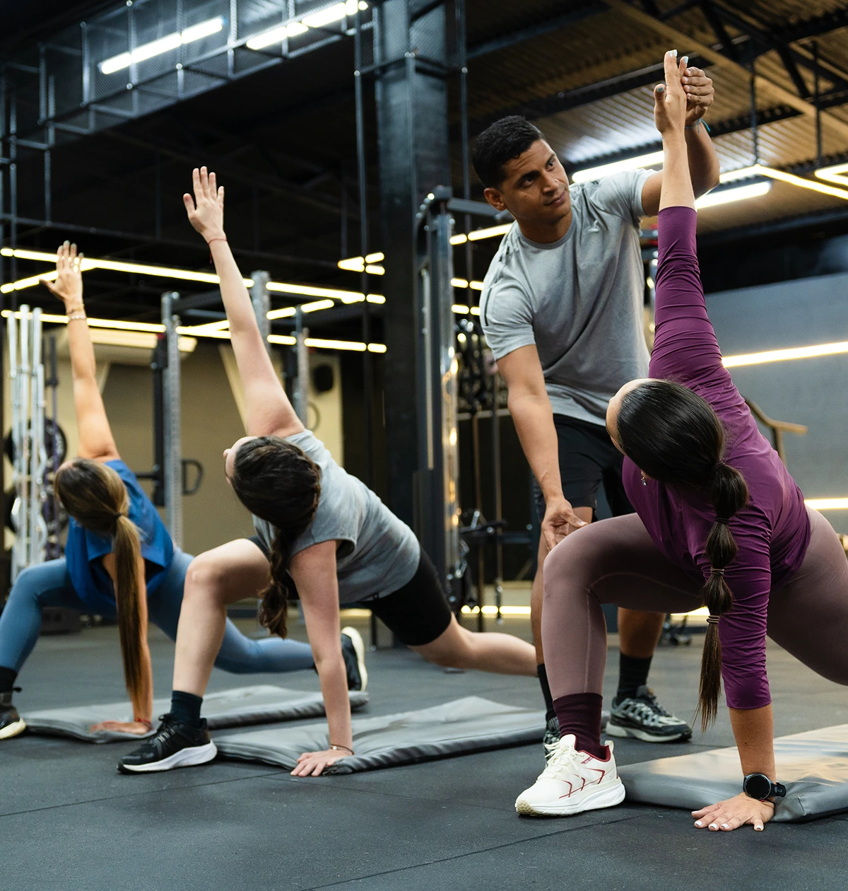Fitness instructor guiding group yoga session.